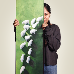 An acrylic painting on board titled 'Harmony in Motion,' featuring white sheep-like abstract forms on a vivid green textured background, held by a person partially visible behind it.