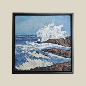 A textured acrylic painting featuring waves crashing against rocky coastal cliffs under a clear blue sky, framed in a sleek black synthetic frame.