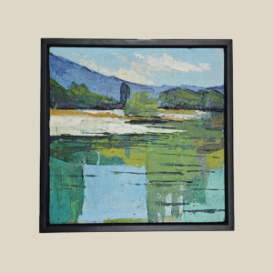 Acrylic painting on canvas depicting a serene lakeside landscape with green foliage, blue hills, and calm water reflections, framed in a minimalist black frame.